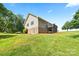 Spacious back exterior featuring a deck and basement entrance on a large lot at 105 Saddlewood Ln, Statesville, NC 28625