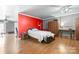 Bedroom with a bright red accent wall, complemented by wood flooring and a ceiling fan at 105 Saddlewood Ln, Statesville, NC 28625