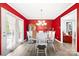 Elegant dining room with bright red walls and patio doors overlooking the pool at 105 Saddlewood Ln, Statesville, NC 28625