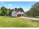 Single story home with garage and driveway set among mature trees and a green lawn at 105 Saddlewood Ln, Statesville, NC 28625