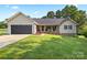 Charming single-story home with a well-manicured lawn and welcoming front porch at 105 Saddlewood Ln, Statesville, NC 28625