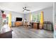 Spacious home office featuring hardwood floors, a ceiling fan, desk, and a large window for ample natural light at 105 Saddlewood Ln, Statesville, NC 28625