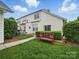 Well-maintained backyard with a bench, lush greenery, and a manicured lawn at 1061 Woodglen Ln, Matthews, NC 28104