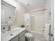 Well-lit bathroom featuring a vanity, mirror, and shower with floral curtain at 1061 Woodglen Ln, Matthews, NC 28104