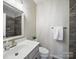 Clean bathroom with modern fixtures, a white vanity, and a decorative mirror at 1061 Woodglen Ln, Matthews, NC 28104