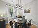 The dining room has a modern light fixture and large window letting in ample natural light at 1061 Woodglen Ln, Matthews, NC 28104