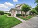 Charming home exterior featuring well-maintained landscaping and a welcoming entryway at 1061 Woodglen Ln, Matthews, NC 28104