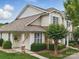 Charming townhome featuring stone accents, a welcoming front door, and a well-maintained lawn and landscaping at 1061 Woodglen Ln, Matthews, NC 28104