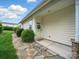 Inviting townhome entrance with a charming wreath, a stone pathway, and well-manicured bushes at 1061 Woodglen Ln, Matthews, NC 28104