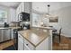 Modern kitchen open to a dining area with contemporary lighting and ample counter space at 1061 Woodglen Ln, Matthews, NC 28104