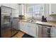 This kitchen is equipped with stainless steel appliances, white cabinets, and a double sink at 1061 Woodglen Ln, Matthews, NC 28104