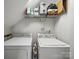 This laundry room has a washer and dryer with storage shelf for supplies and cleaning products at 1061 Woodglen Ln, Matthews, NC 28104