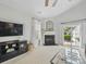 Bright and open living area with fireplace, TV, and sliding door access to outdoor space at 1061 Woodglen Ln, Matthews, NC 28104