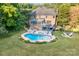 Expansive aerial view of a home with a pool, multiple decks, and beautifully landscaped backyard at 1115 Maremont Ct, Matthews, NC 28104
