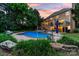 Expansive backyard featuring a sparkling pool, jacuzzi, and landscaped yard ideal for outdoor enjoyment at 1115 Maremont Ct, Matthews, NC 28104