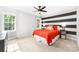 Bright bedroom with large windows and a black and white accent wall at 1115 Maremont Ct, Matthews, NC 28104