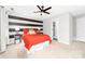 Bedroom with black and white striped accent wall and red bedding at 1115 Maremont Ct, Matthews, NC 28104