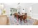 Dining room with hardwood table, seating for six, and large windows at 1115 Maremont Ct, Matthews, NC 28104