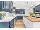 Well-lit kitchen with stainless appliances, center island, hardwood floors, and custom cabinets at 1115 Maremont Ct, Matthews, NC 28104
