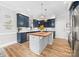 Inviting kitchen features custom cabinets, a center island with cooktop, and stainless steel appliances at 1115 Maremont Ct, Matthews, NC 28104