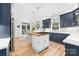 Bright, open kitchen with center island, stainless appliances, adjacent breakfast area, and natural light at 1115 Maremont Ct, Matthews, NC 28104