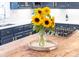 Close-up of kitchen island with wood countertop and sunflowers, showcasing the kitchen's features at 1115 Maremont Ct, Matthews, NC 28104
