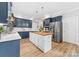 Stylish kitchen with stainless appliances, center island, hardwood floors, and custom cabinets at 1115 Maremont Ct, Matthews, NC 28104