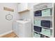 Functional laundry room with washer, dryer, and ample storage shelves at 1115 Maremont Ct, Matthews, NC 28104