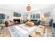 Bright living room features a fireplace, large windows, and comfortable seating at 1115 Maremont Ct, Matthews, NC 28104