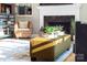 Cozy living room with fireplace, accent chair, and ample natural light at 1115 Maremont Ct, Matthews, NC 28104