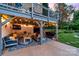 Cozy outdoor living space with comfortable seating, TV, string lights, and well-manicured lawn at 1115 Maremont Ct, Matthews, NC 28104