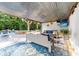 Relaxing outdoor living area with plush seating, a TV, and access to a pool and beautifully landscaped yard at 1115 Maremont Ct, Matthews, NC 28104
