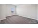 Inviting bedroom featuring neutral carpeting, a bright window, and ample space at 1213 Margo Mannor Dr, Fort Mill, SC 29708