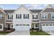 Charming two-story townhome with white siding, black shutters, and a two-car garage at 1213 Margo Mannor Dr, Fort Mill, SC 29708