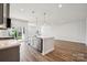 Modern kitchen with stainless steel appliances, kitchen island, and wood floors at 1213 Margo Mannor Dr, Fort Mill, SC 29708