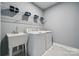 Functional laundry room with a utility sink, washer, and dryer for efficient laundry chores at 1213 Margo Mannor Dr, Fort Mill, SC 29708