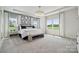 Bright main bedroom featuring large windows, tray ceilings, and neutral colors, creating a serene retreat at 1213 Margo Mannor Dr, Fort Mill, SC 29708