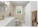 Bright bathroom with white vanity, modern fixtures, and shower with curtain at 1226 Tarrington Ave, Charlotte, NC 28205
