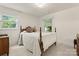 Comfortable bedroom with carpet and two windows providing bright natural light at 1226 Tarrington Ave, Charlotte, NC 28205