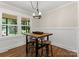Inviting dining area with a rustic table, bar stools, and bright windows overlooking the outdoors at 1226 Tarrington Ave, Charlotte, NC 28205