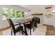 Bright dining room with large windows, hardwood floors, brick fireplace, and modern furniture at 1226 Tarrington Ave, Charlotte, NC 28205