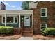 Welcoming front entrance with a classic brick facade, green accents, and manicured landscaping at 1226 Tarrington Ave, Charlotte, NC 28205