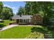 Charming home with green siding, brick accents, and a well-manicured front lawn at 1226 Tarrington Ave, Charlotte, NC 28205