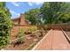 Garden area featuring brick wall and walkway, and planting areas for vegetables and flowers at 1226 Tarrington Ave, Charlotte, NC 28205