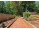 Beautiful garden area with brick pathway, wooden planters, and lush greenery at 1226 Tarrington Ave, Charlotte, NC 28205