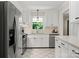 Well-lit kitchen with stainless steel appliances, white cabinets, and a clean, modern design at 1226 Tarrington Ave, Charlotte, NC 28205