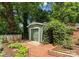 Garden area featuring outbuilding and garage with green doors and well-maintained landscaping at 1226 Tarrington Ave, Charlotte, NC 28205