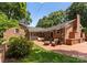 Outdoor patio with brick flooring, fireplace, and seating area provides a cozy outdoor space at 1226 Tarrington Ave, Charlotte, NC 28205