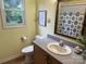 A bright bathroom features a window, patterned shower curtain, and a taupe vanity at 1228 Hidden Creek Cir, Hickory, NC 28602