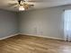 Well-lit bedroom featuring hardwood floors, neutral walls, ceiling fan, and bright window at 1228 Hidden Creek Cir, Hickory, NC 28602